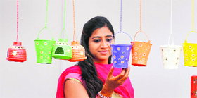A girl displays her creations during an exhibition in Ludhiana.