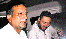 ASI Jagmal Singh (left) in a vehicle