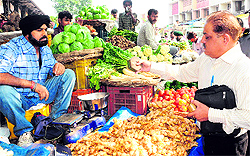 A Weight and Measurement Inspector checks a vendors stall at the vegetable market in Sector 26, Chandigarh, on Saturday