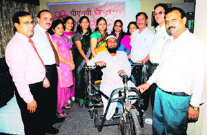 A differently-abled person gets a tricycle at a function organised by the PNB Prerna in Dehradun on Saturday.