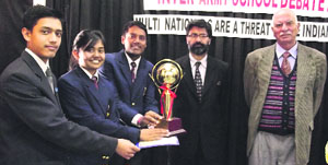 A team of Army Public School, Dagshai, receives the trophy from chief guest Harish Dhillon at Dagshai on Saturday.