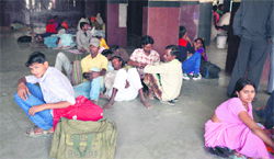 Passengers sit on the floor in the absence of adequate number of benches in the waiting rooms and on the platforms at the Ludhiana railway station. Photo: Inderjeet Verma