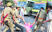 Policemen whisk away a protesting VHP activist in Allahabad on Saturday. PTI