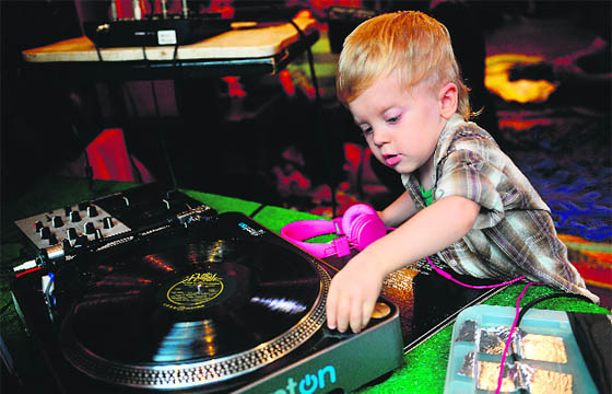 A toddler takes part in a “Baby DJ School” class in New York. The class aims to teach preschool children to learn the basics of mixing music. The eight-week course is geared towards the under-three set, kids are put behind a deck, mixing and matching musical tracks.