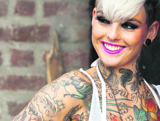 A tattoo enthusiast poses at the London Tattoo Convention in London. More than 300 tattoo artists from around the world are showcasing their body art in 26 halls at the convention, which also features live music and tattoo competitions.