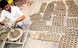 A potter busy making earthen lamps ahead of Diwali at Sarabha Nagar in Bathinda on Sunday