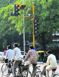 Cyclists jump a red light at the Sectors 22/23 traffic signal.