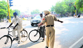A policeman asks cyclists to use a cycle track on the road separating Sectors 22 and 23 in Chandigarh.
