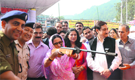 MP Pratibha Singh shoots on a target during a Red Cross fair in Mandi on Sunday. 