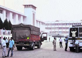 Security personnel check vehicles carrying official record to the Civil Secretariat as part of the Durbar Move, in Jammu on Sunday