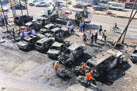 Municipal workers clear the site of a car bomb attack in Shiite neighbourhoods of Baghdad in Iraq on Sunday