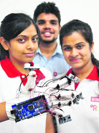 Students show the innovative glove in Chandigarh. 