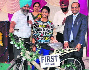 Kumar Abhay, IAS, gives a cycle to a lucky draw winner at Guru Nanak Khalsa Senior Secondary School in Sector 30, Chandigarh. 