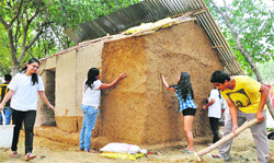 Architecture students demonstrate construction and design of a model dwelling unit meant for rehabilitation of the victims of natural disasters at Gurgaon. Tribune photo: Sayeed Ahmed