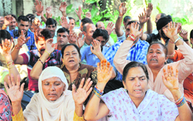Government employees stage a protest in Jammu on Monday.