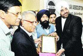 Former acting president of Pakistan Wassim Sajjad receives his birth certificate from MCJ officials in Jalandhar on Monday. 