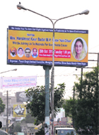A unipole carries a poster of MP Harsimrat Kaur Badal in Ludhiana on Monday. 