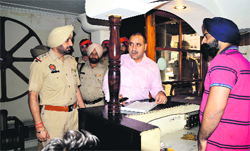 Raj Kumar, ACP (North), accompanied by other police officers, checks the record at a hotel.