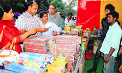 Mohammed Shayin, UT Deputy Commissioner, inspects the licence of a stall owner selling firecrackers at the Sector 26 Grain Market in Chandigarh. Tribune photo: Parvesh Chauhan