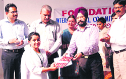 A winner of the symposium competition being given a prize in Reasi on Tuesday. A Tribune photograph 