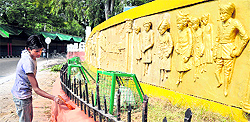 A worker busy giving facelift to a road near the Civil Secretariat ahead of the Durbar Move in Jammu on Wednesday