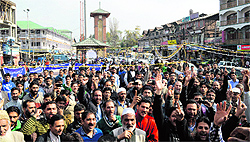 Members of the Kashmir Economic Alliance protest over the sealing of commercial establishments in Srinagar on Wednesday