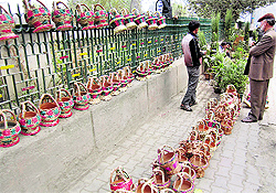 A vendor sells kangris on a roadside in Srinagar on Wednesday