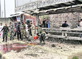 Securitymen at the Moirangkhom bus stand in Imphal after a blast on Wednesday