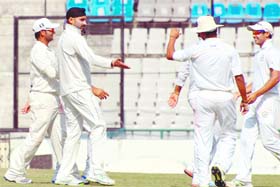 Punjab teams Harbhajan Singh celebrates with teammates after an Odisha dismissal on the final day of their Ranji Trophy match in Mohali on Wednesday