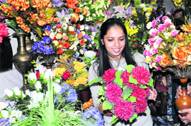 A girl selects flowers for decoration ahead of Diwali at a shop in Dhobi Bazar.