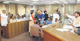Local MP Pawan Kumar Bansal (extreme left) tries to reply to allegations made by the BJP amid protests during the MC House meeting in Chandigarh on Thursday