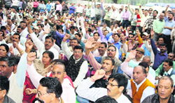 Striking state government employees hold a demonstration in support of their demands at Parade Ground in Dehradun on Thursday. A Tribune photograph