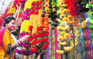 A woman looks at decorative items in a market, buzzing with activities, as residents get busy shopping for Diwali in Jammu on Thursday.