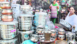 A buyer at a stall of utensils ahead of Dhanteras in Ludhiana on Thursday. Tribune photo