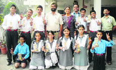 The Principal and the in charge of sports, BVM Senior Secondary School, Udham Singh Nagar, pose with the medal winners. A Tribune photograph