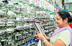 A woman purchases utensils on the occasion of Dhanteras in Amritsar on Friday