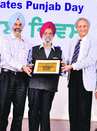 CUP Vice-Chancellor Jai Rup Singh (left) presents a memento to former PAU VC MS Kang (right) on the Central University of Punjab campus on Friday. 
