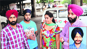 Family members and son (extreme left) of Gurbachan Singh (inset), outside the GMCH, Sector 32, Chandigharh, on Friday. 