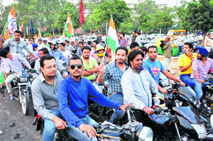 Activists of the Youth Congress violate traffic rules during the inauguration of the overbridge in Sector 17, Chandigarh, on Friday. 