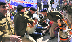 Policemen stop the protesting shiksha acharyas from marching towards Chief Minister Vijay Bahugunas residence in Dehradun on Friday. A Tribune photograph