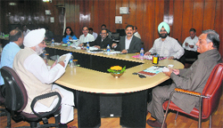 Chief Minister Vijay Bahuguna and chairman of the State Minorities Commission Narendrajit Bindra at a meeting in Dehradun on Friday. A Tribune photograph