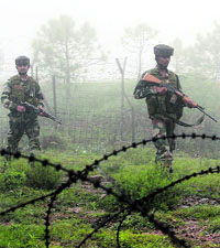 Army jawans patrol along the LoC fence.