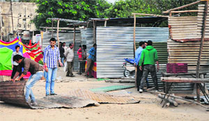 Workers install cracker stalls in Parade Ground, Jammu, on Friday. 