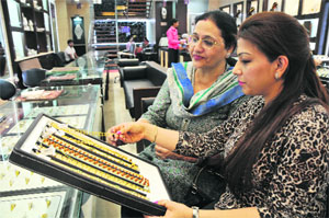 Women buy gold jewellery on the occasion of Dhanteras ahead of Diwali in Jammu on Friday.