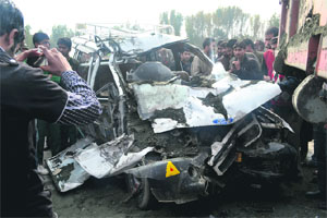 The car that was crushed in a collision with a tipper lorry on the Srinagar-Jammu National Highway in the Barsoo area on Friday.