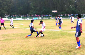 A footballer tries to dribble the ball during the JKPDC Football League final between J&K Forest and Jammu and Kashmir Bank at the Polo Ground in Srinagar on Friday. 