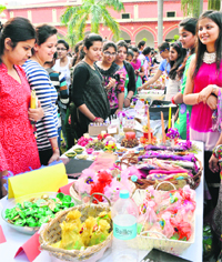Students of the Khalsa College for Women take a look at the candles and other articles displayed at the college in Ludhiana on Friday.