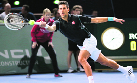Novak Djokovic returns a shot to Stanislas Wawrinka during their quarterfinal at the ninth and final ATP World Tour Masters 1000 indoor tournament in Paris on Friday.
