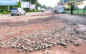 A road leading to the city railway station in bad shape.