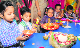 Children make preparations for the Diwali celebrations in Chandigarh.
